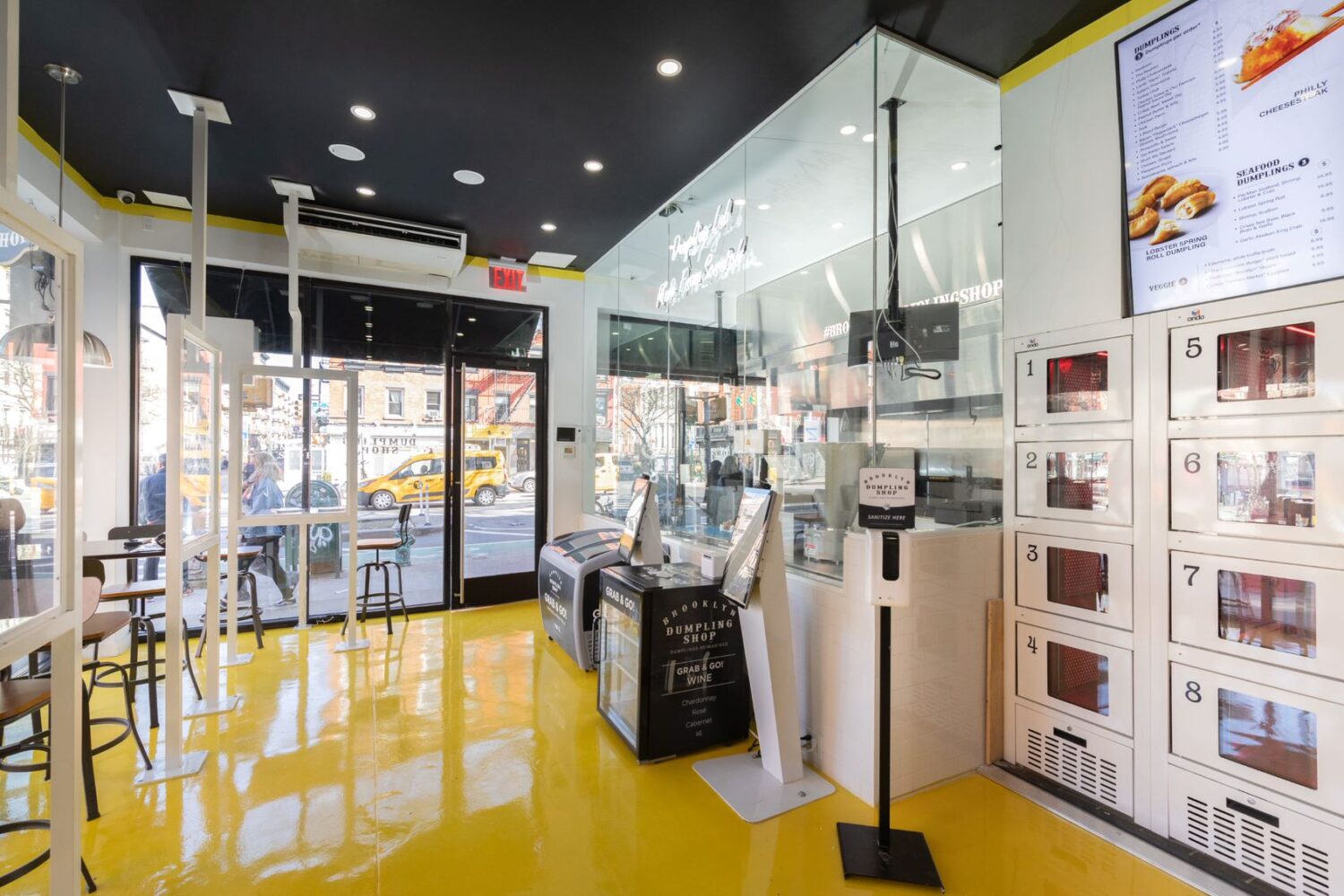 Interior image of a store with black ceiling and shiny yellow floors