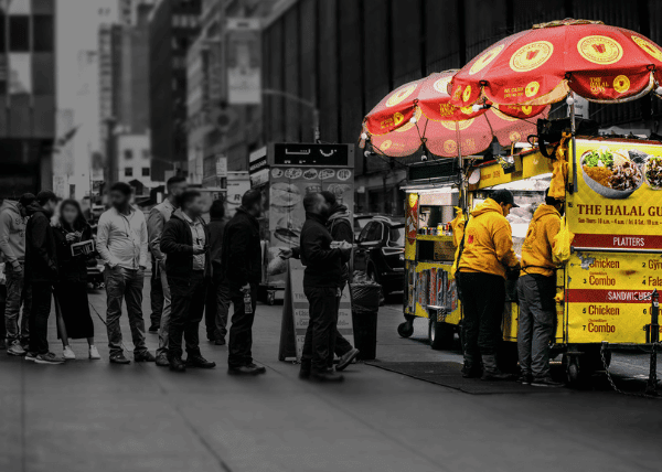 People waiting in line at the halal guys cart 