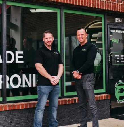 PayMore Founders Photo of PayMore Founders in front of store.