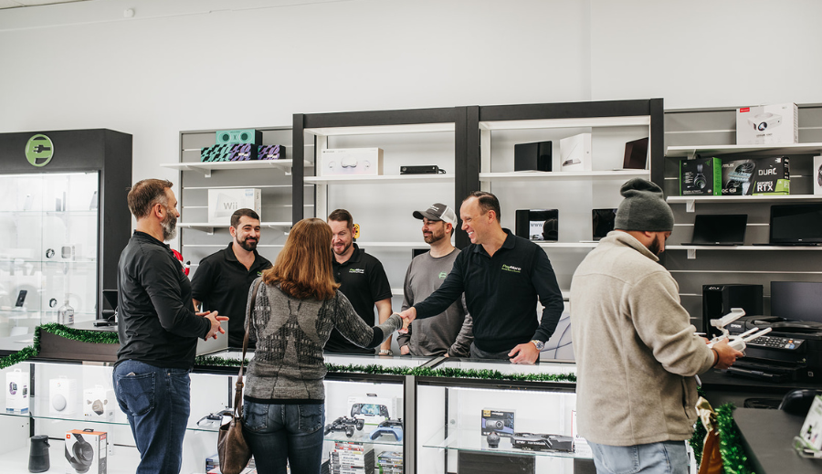 PayMore founders shaking new franchisees hands