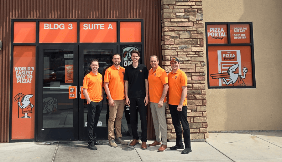 Wes Swaney and family in front of one of their little Caesars location