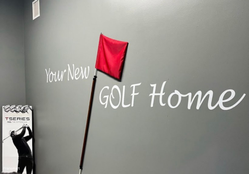 Swing Bays wall with writing that says your new golf home